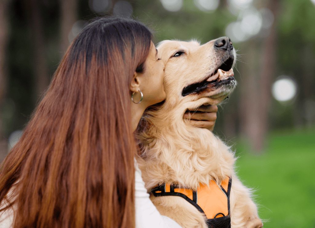 a woman makes a dog mistake and hugs her pup