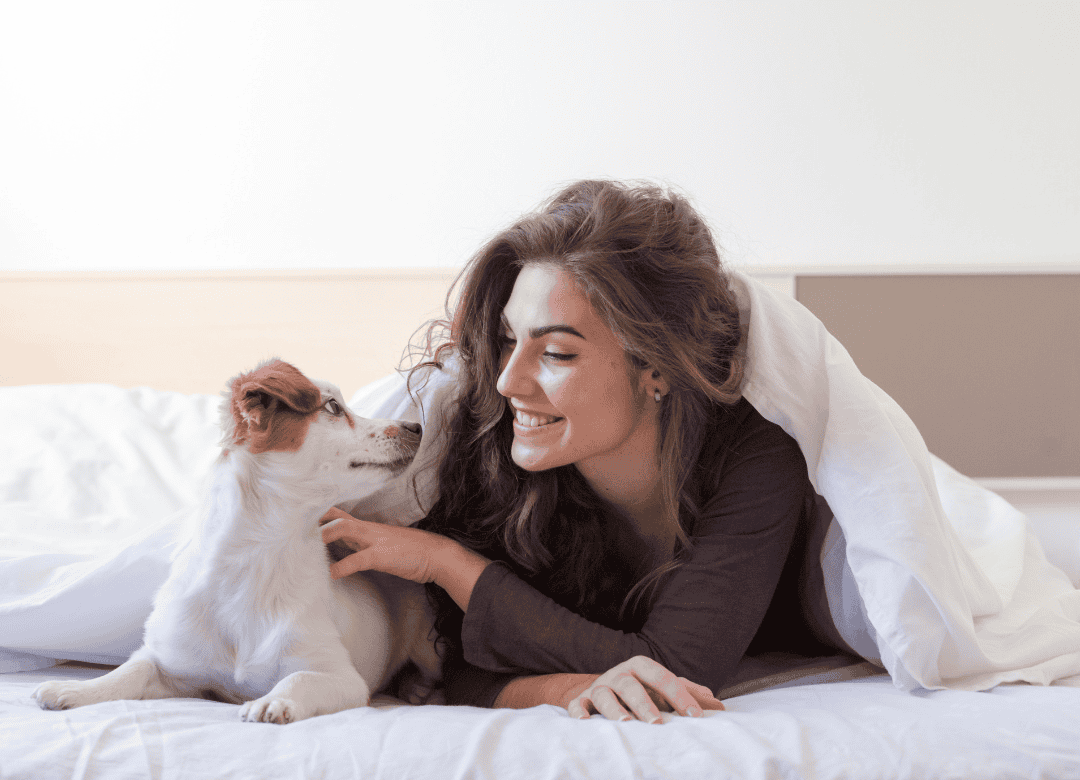 A woman tells her pup he's a good boy as part of a dog Happy Valentine's Day celebration.