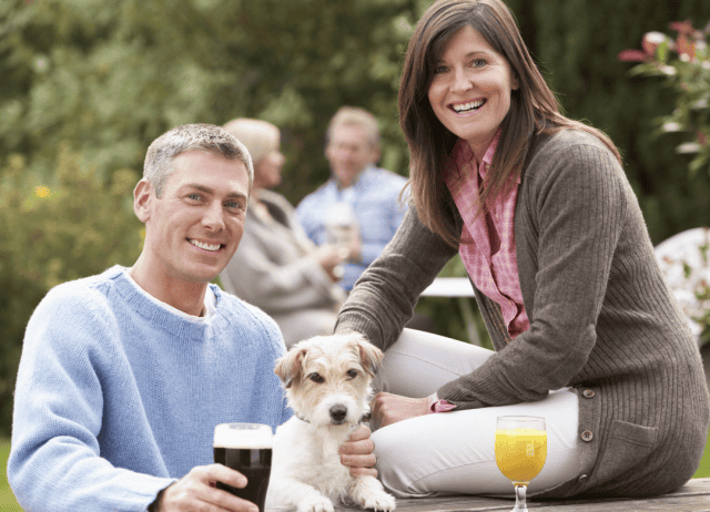 a couple and their fur kid visits a brewery on their dog dog
