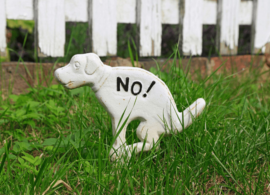 a sign that tells dog parents to not use their yard as a dog poop disposal area