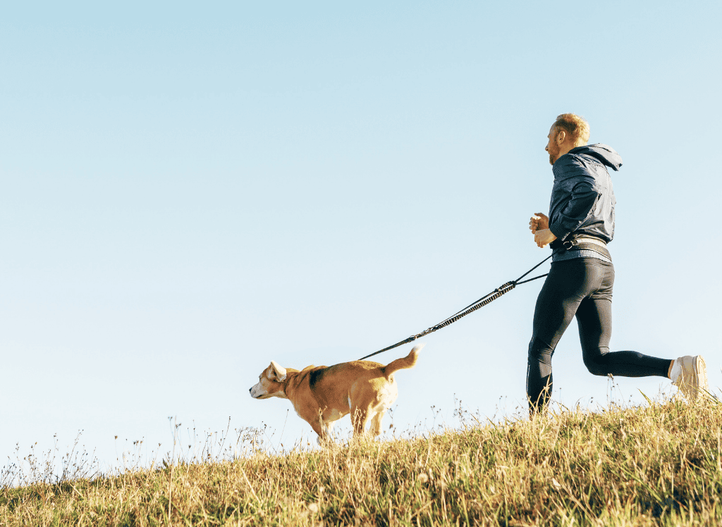 a man runs with his dog